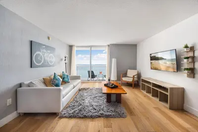 a living room with a white couch and a table at Brickell Apartments with Oceanview in Miami