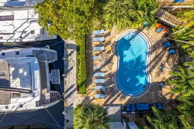 an overhead view of a swimming pool with palm trees at Isle of Venice Residence and Marina in Fort Lauderdale