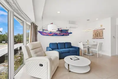 a living room with a blue couch and a table at Isle of Venice Residence and Marina in Fort Lauderdale
