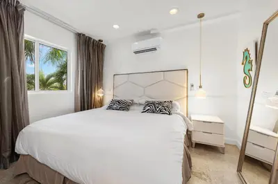 a bedroom with a large white bed and a window at Isle of Venice Residence and Marina in Fort Lauderdale