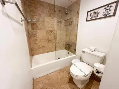 a bathroom with a shower and a toilet and a tub at Amplio y moderno departamento con acceso directo a la playa in Hollywood