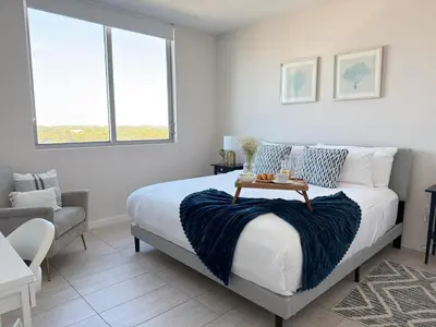 a bedroom with a bed with a table on it at Desing district, great apartment in Miami