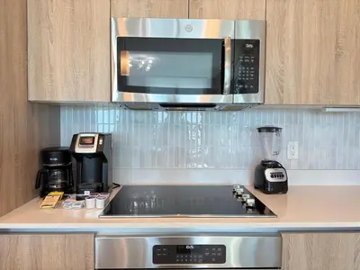 a kitchen with a microwave and a stove top oven at Desing district, great apartment in Miami