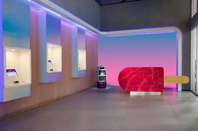 a red chair in a room with a pink and purple wall at YOTEL Miami in Miami