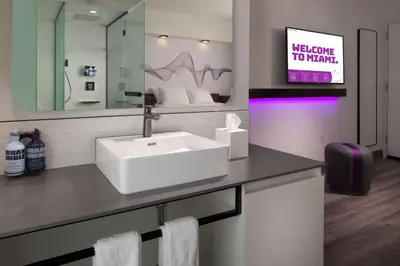a bathroom with a sink and a mirror at YOTEL Miami in Miami