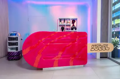 a bright red couch in a room with a sign at YOTELPAD Miami in Miami