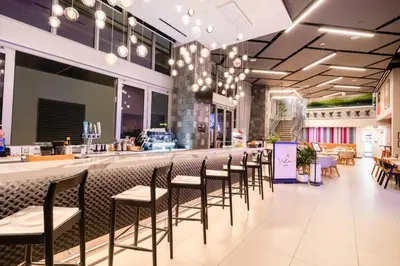 a bar with chairs and a counter in a restaurant at YOTELPAD Miami in Miami