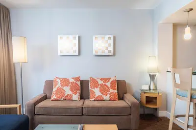 a living room with a couch and two pillows at Sunny Isles 1BDR Sea View and Pool in Miami Beach
