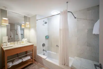 a bathroom with a tub and a sink and a shower at Sunny Isles 1BDR Sea View and Pool in Miami Beach