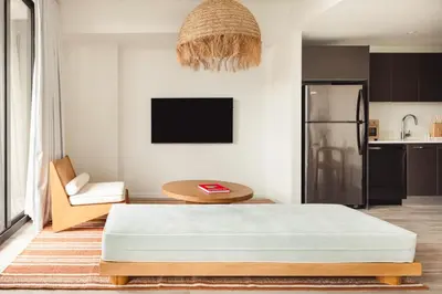 a living room with a bed and a table at Flow Hotel Fort Lauderdale in Fort Lauderdale