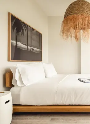 a bedroom with a white bed with a picture on the wall at Flow Hotel Fort Lauderdale in Fort Lauderdale