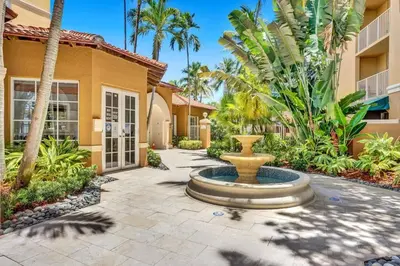 a courtyard with a fountain in front of a building at Yacht Club at aventura Amazing Marina view parking included in Miami