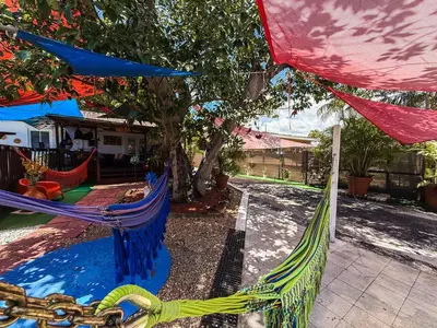 a playground with two hammocks in a yard at Hammocks & mini-golf! 10 mins from Beach! in Hollywood