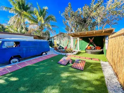 a yard with a blue van parked next to a garden at Hammocks & mini-golf! 10 mins from Beach! in Hollywood