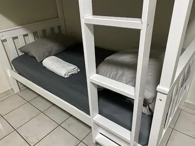 a room with a bunk bed with a pillow at Single Size BOTTOM Bunk Bed - Mixed Shared ROOM in Miami