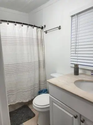 a bathroom with a toilet and a shower and a sink at 13101 Main Apartment Miami in Miami