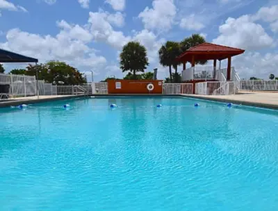 a large blue swimming pool with a gazebo at 13101 Main Apartment Miami in Miami
