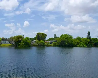 a large body of water with trees in the background at 13101 Main Apartment Miami in Miami