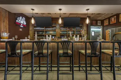 a bar with black chairs in a restaurant at Best Western Plus North Miami-Bal Harbour in North Miami