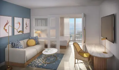 a living room with a couch and a bedroom at The Sunny in Sunny Isles Beach