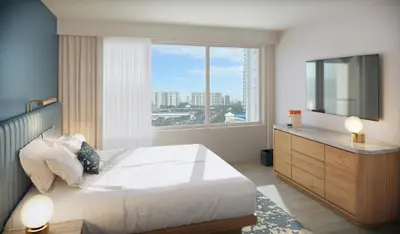 a bedroom with a large bed and a large window at The Sunny in Sunny Isles Beach