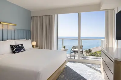 a bedroom with a bed and a view of the ocean at The Sunny in Sunny Isles Beach