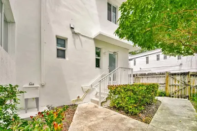a white building with a staircase in front of it at West Deco in Miami Beach