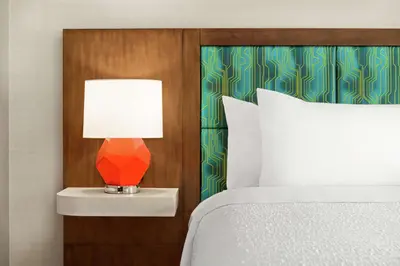 a bed with a lamp on a night stand next to a bed at Hampton Inn & Suites Miami, Kendall, Executive Airport in Kendall