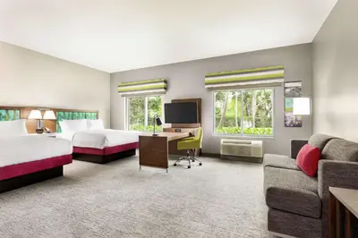 a hotel room with two beds and a desk at Hampton Inn & Suites Miami, Kendall, Executive Airport in Kendall