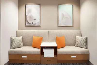 a waiting room with a couch and two pillows at Hampton Inn & Suites Miami, Kendall, Executive Airport in Kendall