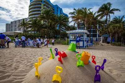 a sand castle on a beach with people and buildings at B Ocean Resort Fort Lauderdale Beach in Fort Lauderdale