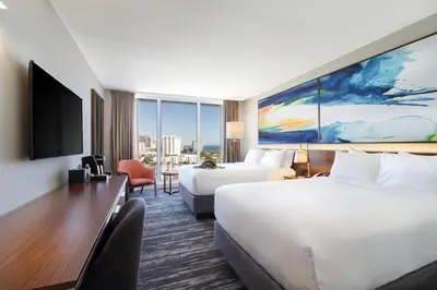 a hotel room with two beds and a flat screen tv at B Ocean Resort Fort Lauderdale Beach in Fort Lauderdale