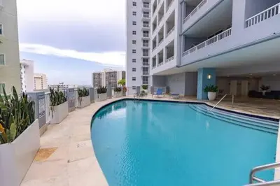a large swimming pool on the side of a building at Comfortable 2 BR at Brickell , Free Parking in Miami
