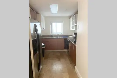 a kitchen with a sink and a refrigerator at Comfortable 2 BR at Brickell , Free Parking in Miami