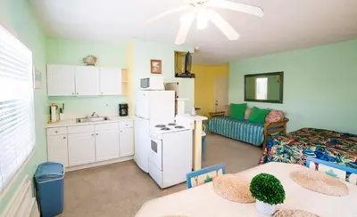 a kitchen and living room with a white refrigerator at Ocean Inn in Hollywood