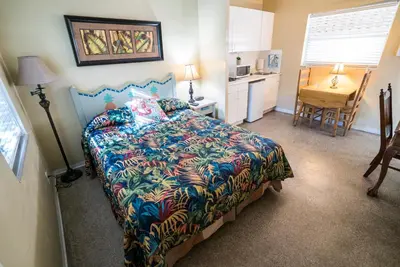 a bedroom with a bed with a colorful bedspread at Ocean Inn in Hollywood