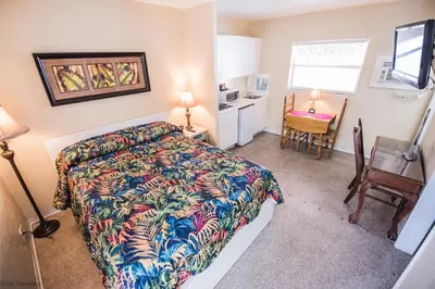 a bedroom with a bed and a kitchen with a desk at Ocean Inn in Hollywood