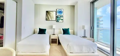 two beds in a room with a window at Million Dollar View at Hyde Resort And Residences in Hollywood
