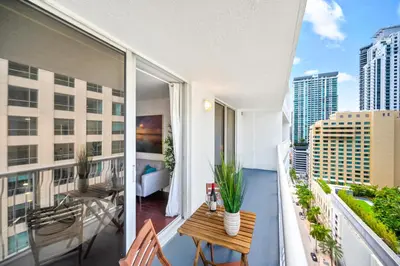 a balcony with a bed and a table on a balcony at Amazing Condo with FREE PARKING in Brickell Miami in Miami
