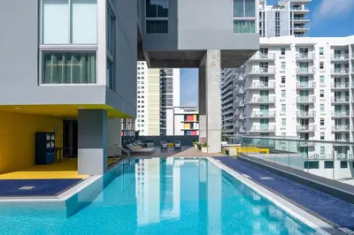 a swimming pool in a building with tall buildings at Atwell Suites Miami Brickell by IHG in Miami
