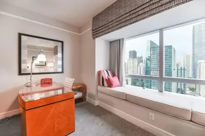 a room with a large window with a desk and a table at Live the Miami Experience in an Exclusive Condo 4S in Miami