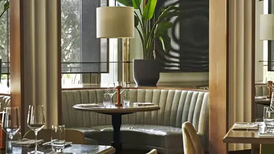 a restaurant with a table and chairs and a window at Live the Miami Experience in an Exclusive Condo 4S in Miami