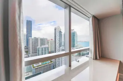 a room with a large window with a view of the city at Live the Miami Experience in an Exclusive Condo 4S in Miami