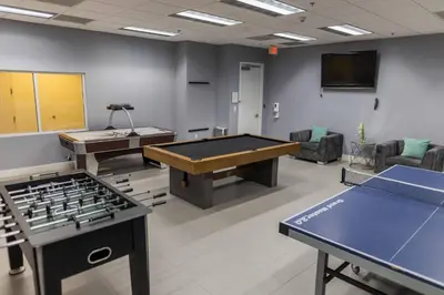 a large room with ping pong tables in it at Luxury Accommodations Brickell in Miami