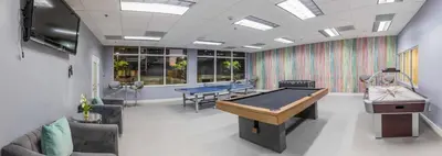 a room with ping pong tables and consoles in it at Luxury Accommodations Brickell in Miami