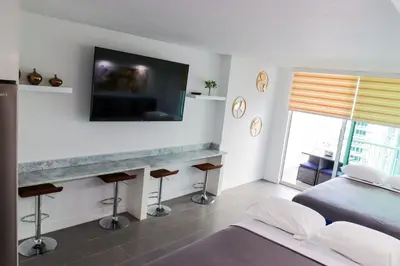 a bedroom with a bed and a tv on the wall at Luxury Accommodations Brickell in Miami