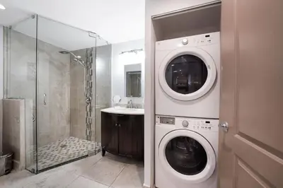 a bathroom with a washing machine and a sink at Home wpool by PMI unit 401 in Fort Lauderdale