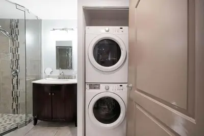 a bathroom with a washing machine and a sink at Home wpool by PMI unit 401 in Fort Lauderdale