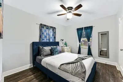 a bedroom with a blue bed with a ceiling fan at Home wworkstation by PMI unit 2908 in Hollywood