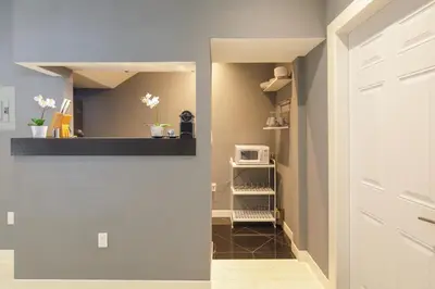 a hallway with a white door and a microwave at Sunny Days Apartments in Miami Beach